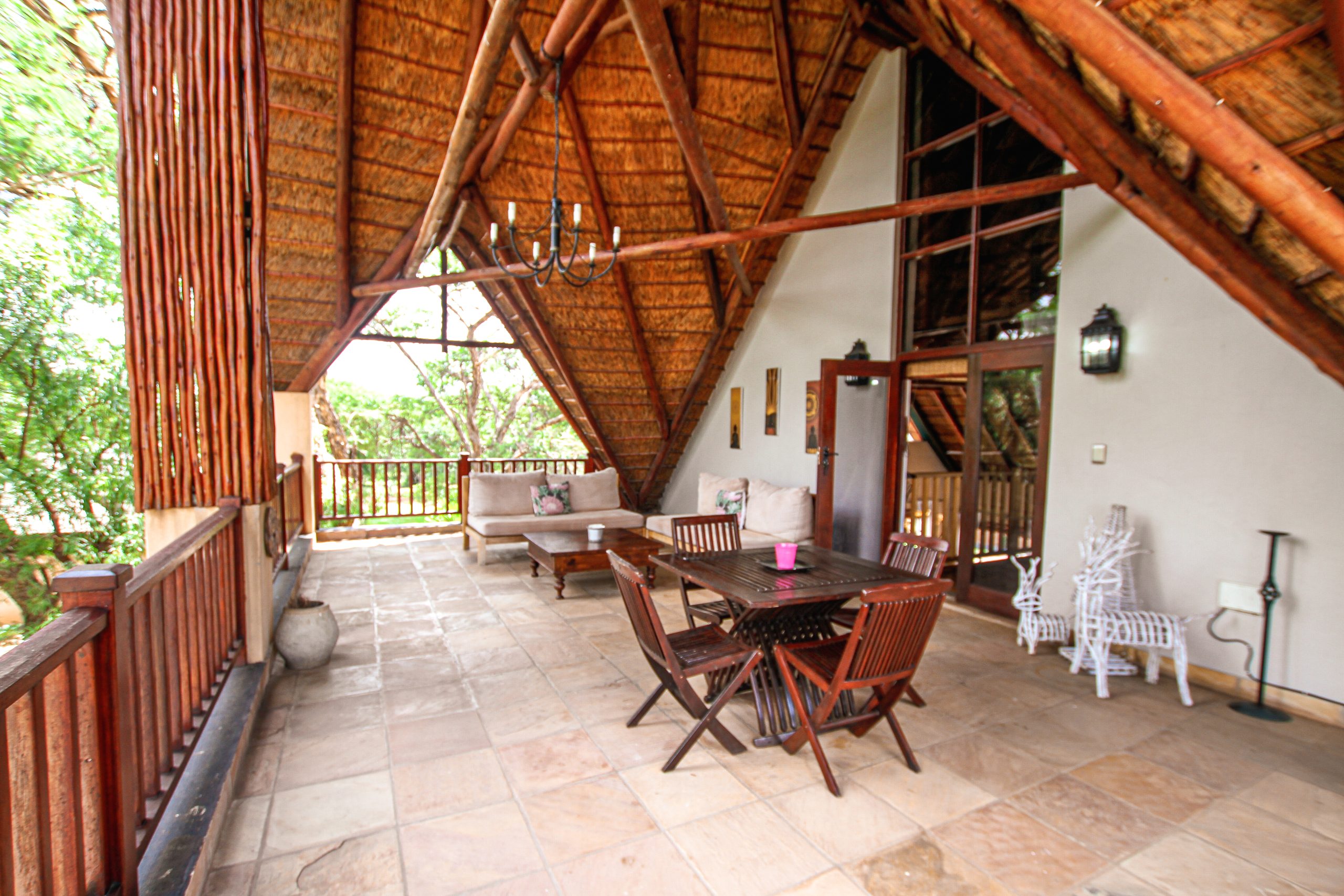 Patio with a table seating and couches with a view