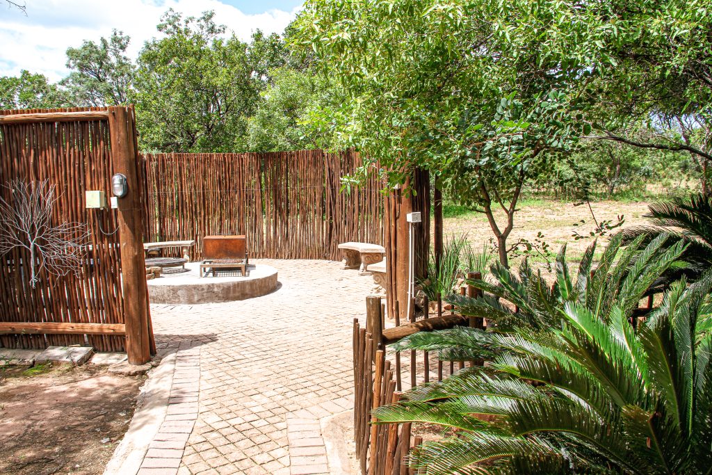 Stone path leading to the boma. Fire pit in the middle