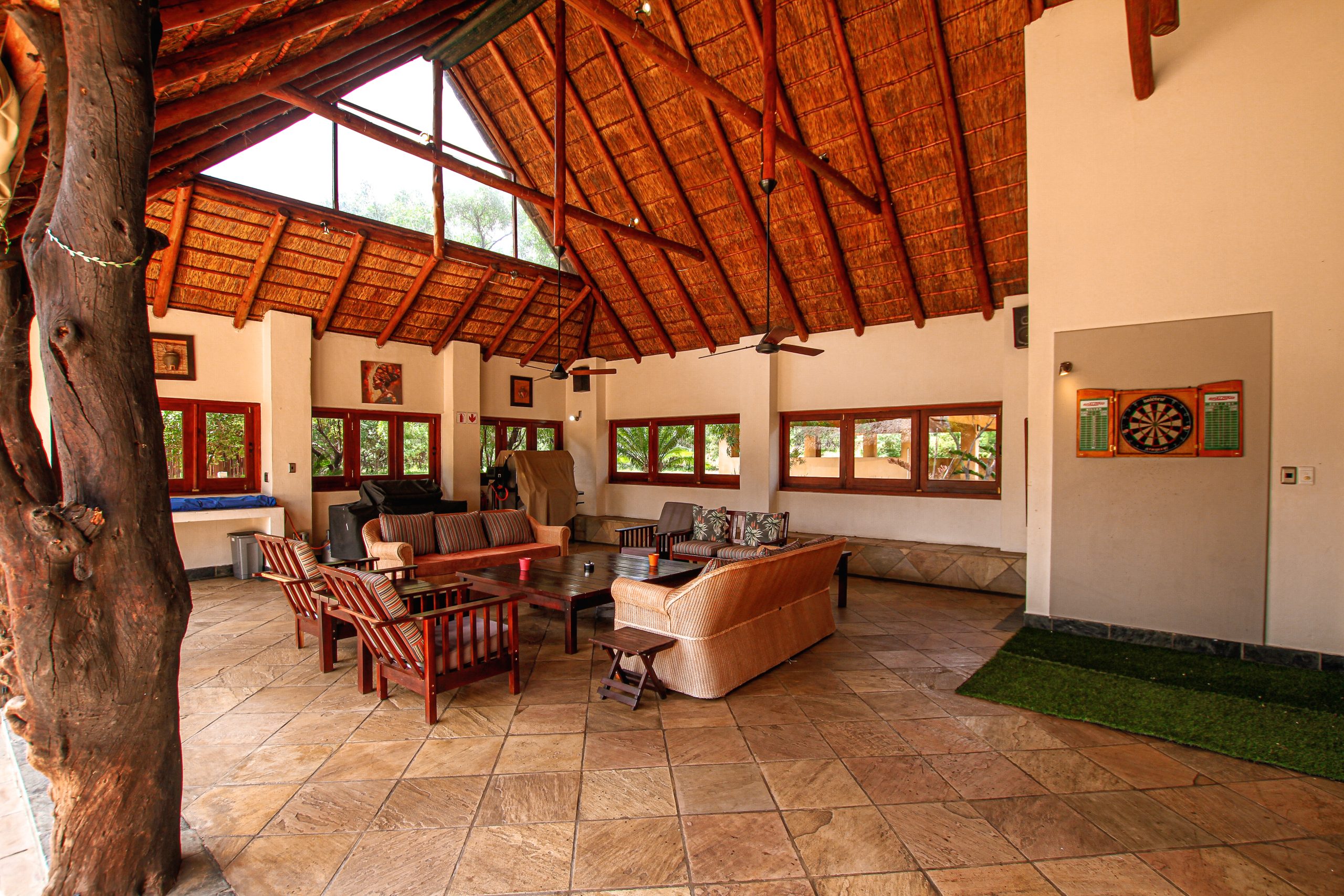 Outside veranda with couches. Straw roofing and light