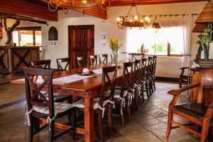 Dining room with large wooden table and 14 chairs